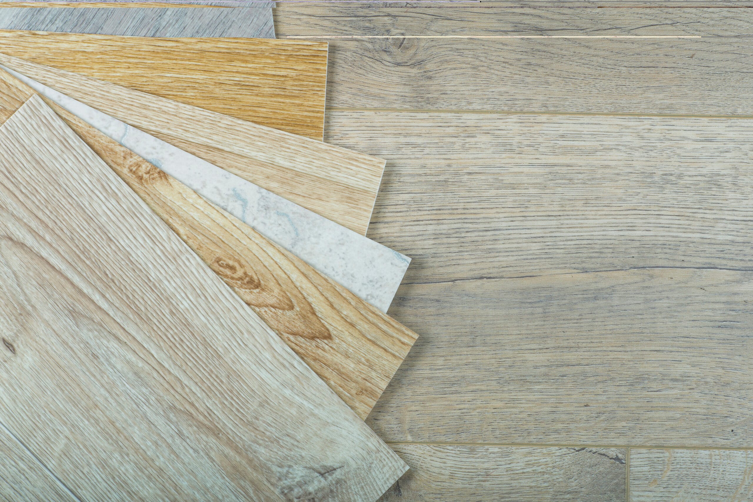 Vinyl and linoleum samples on a wooden background. Vinyl for flo